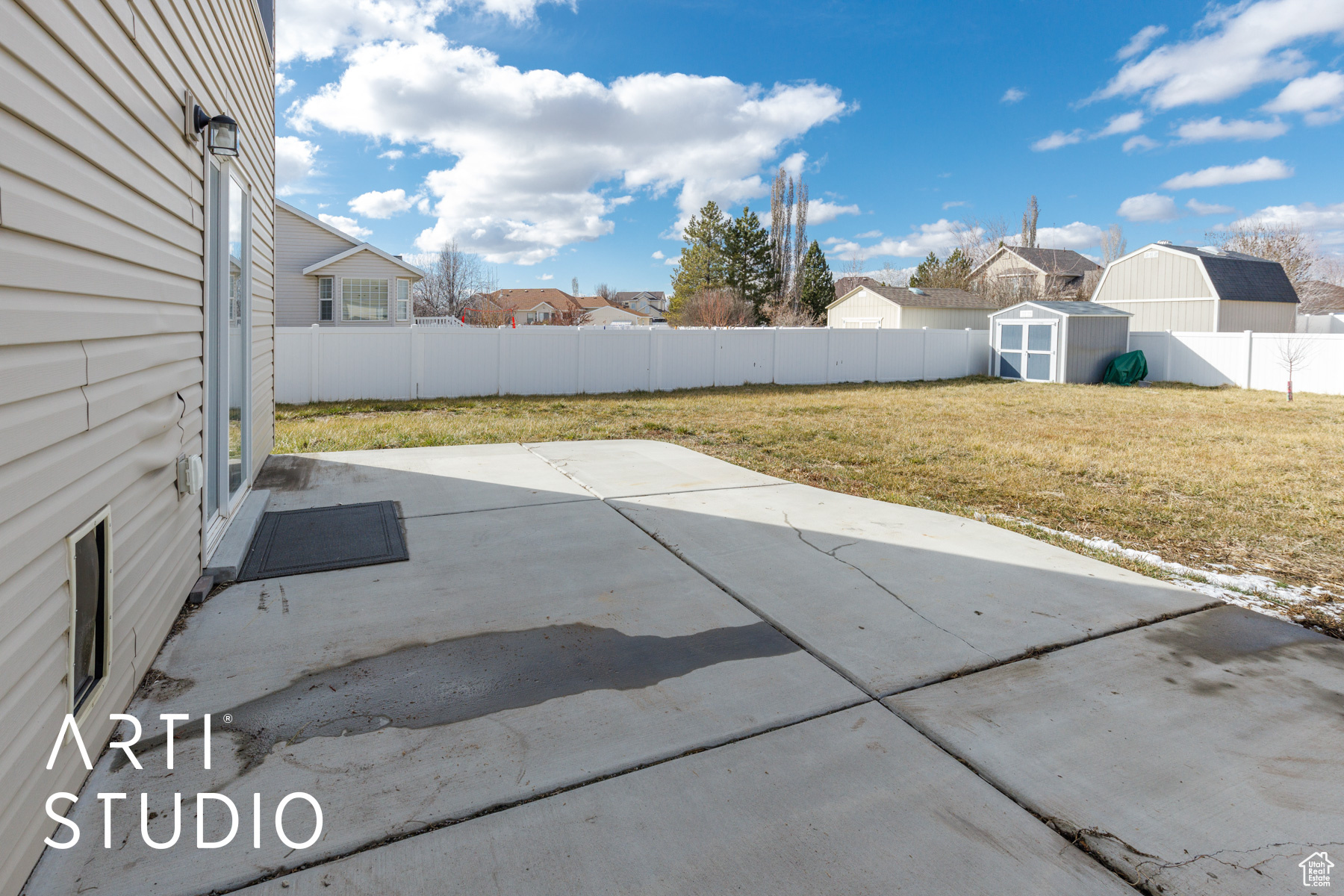 View of patio featuring a storage shed, a fenced backyard, and an outbuilding