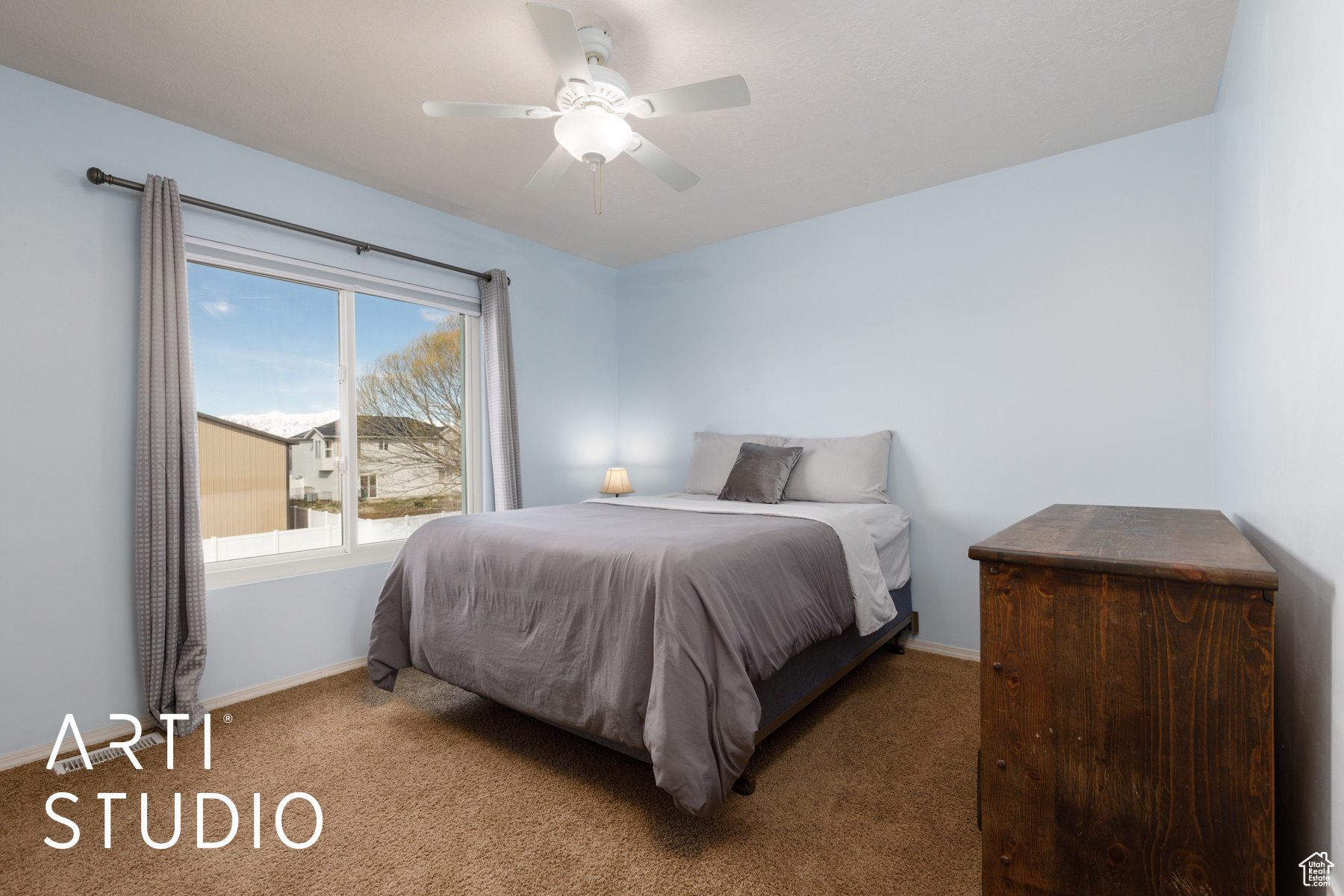 Carpeted bedroom with ceiling fan and baseboards