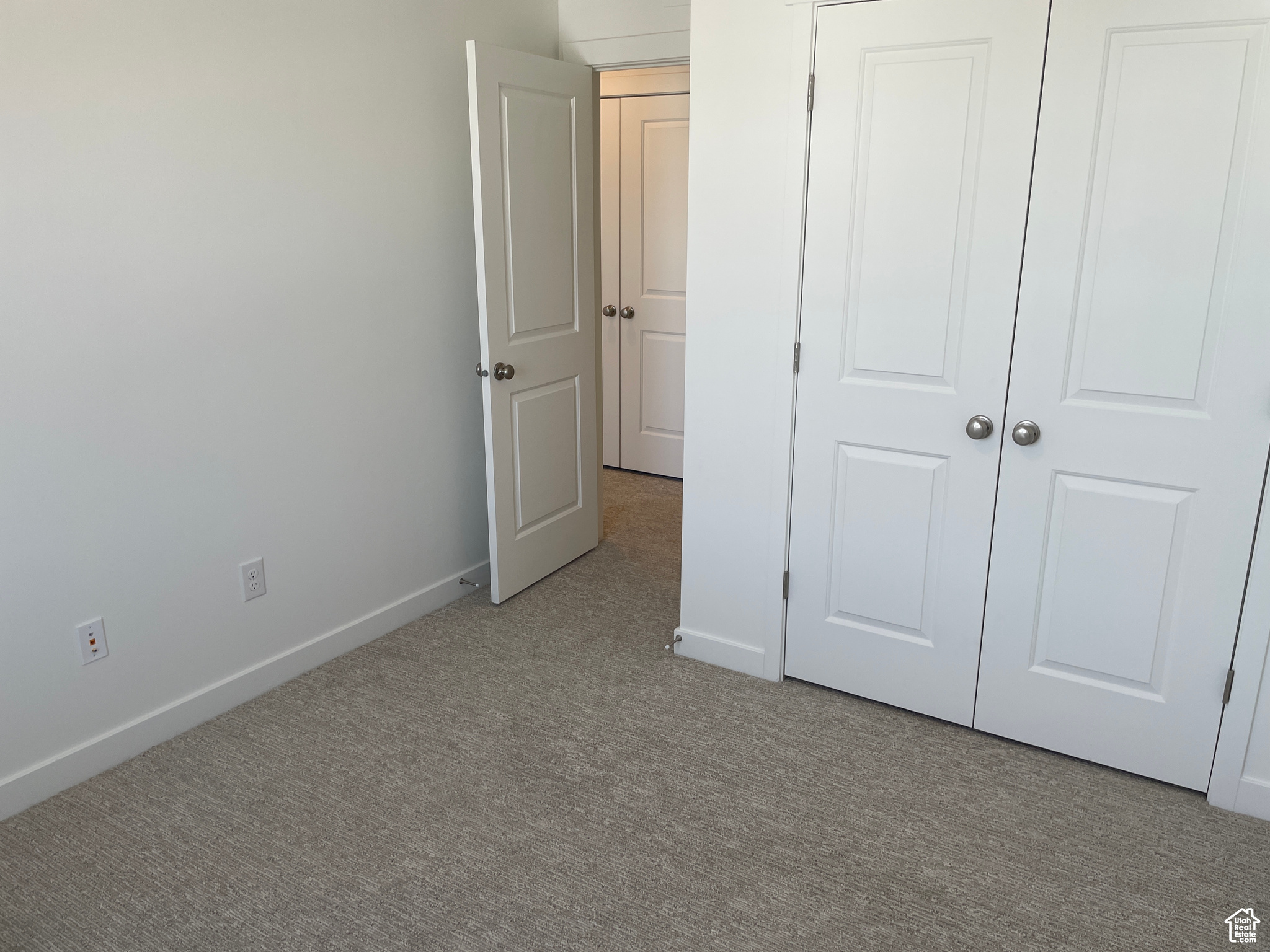 Unfurnished bedroom featuring baseboards and carpet flooring
