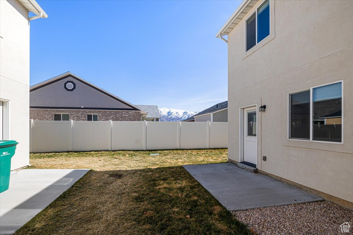 View of yard with a patio and fence