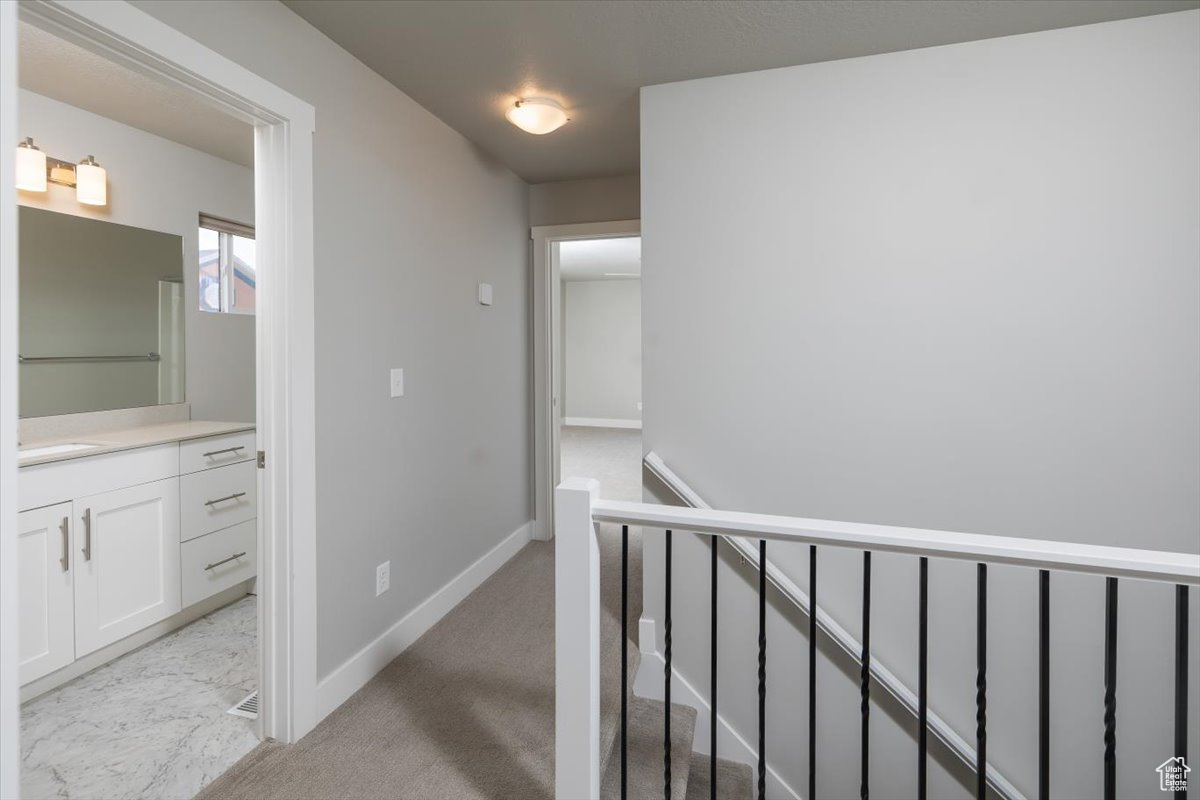 Hallway featuring baseboards