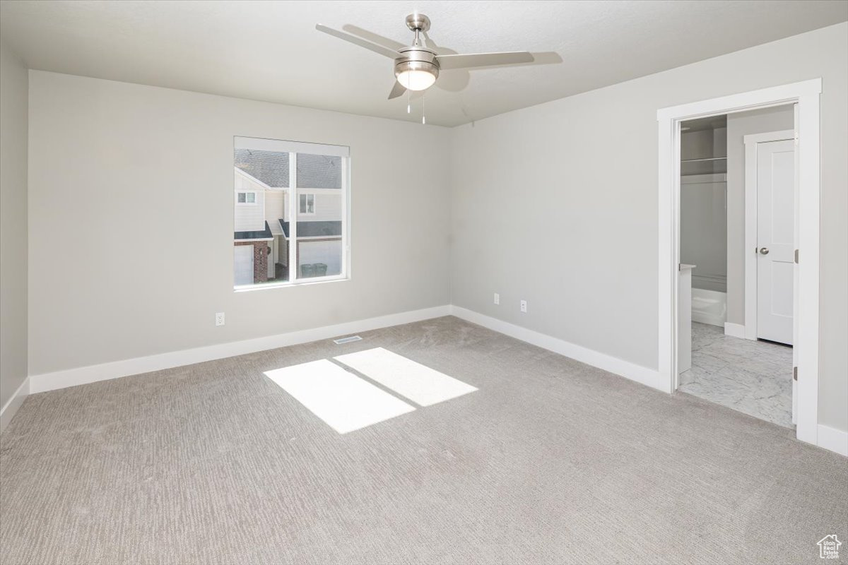 Unfurnished bedroom with carpet flooring, a ceiling fan, and baseboards