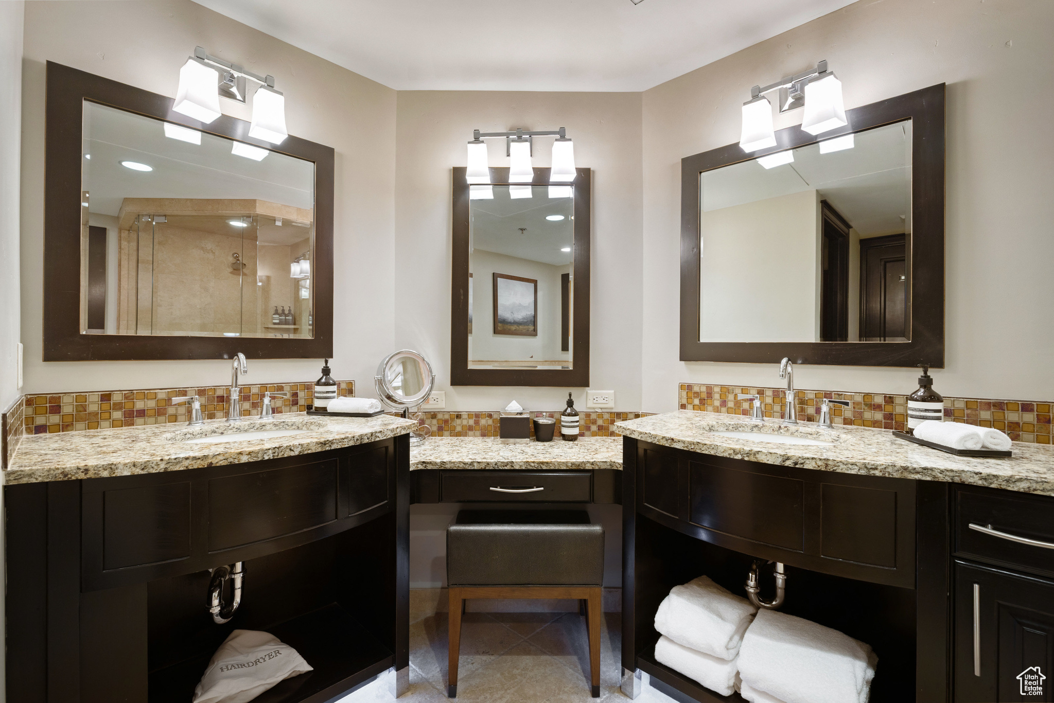 Full bathroom featuring tile patterned floors, decorative backsplash, a stall shower, and vanity