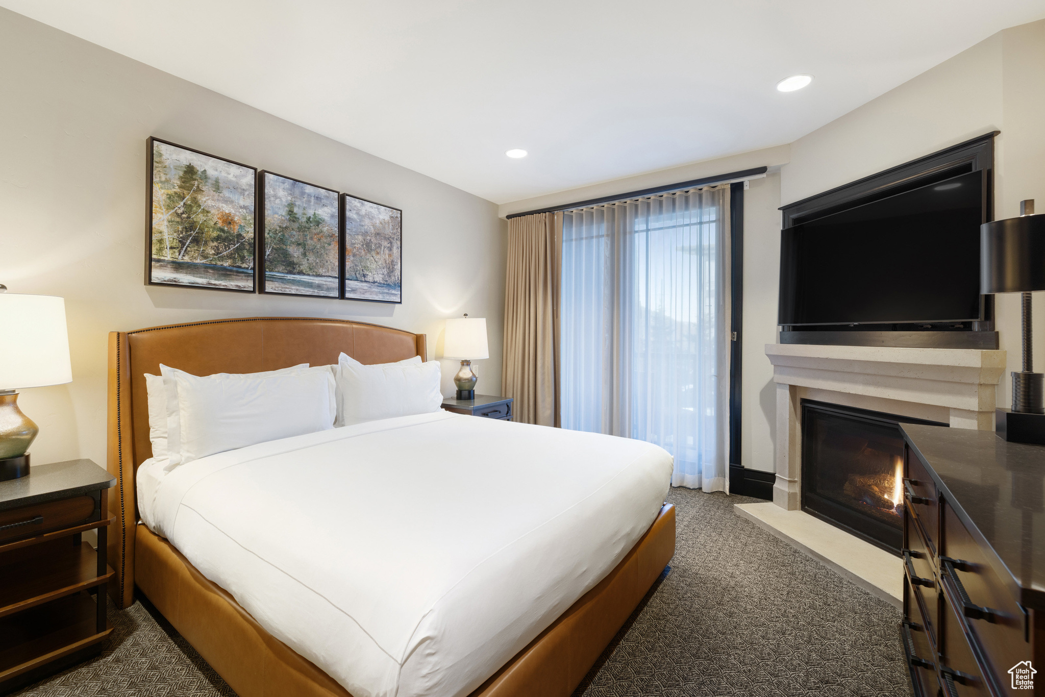 Bedroom with a fireplace with flush hearth, recessed lighting, and carpet