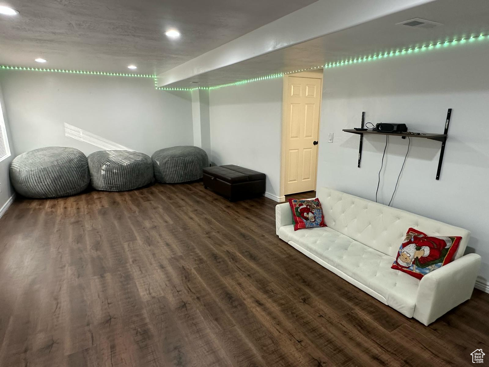 Finished basement featuring visible vents, wood finished floors, and recessed lighting