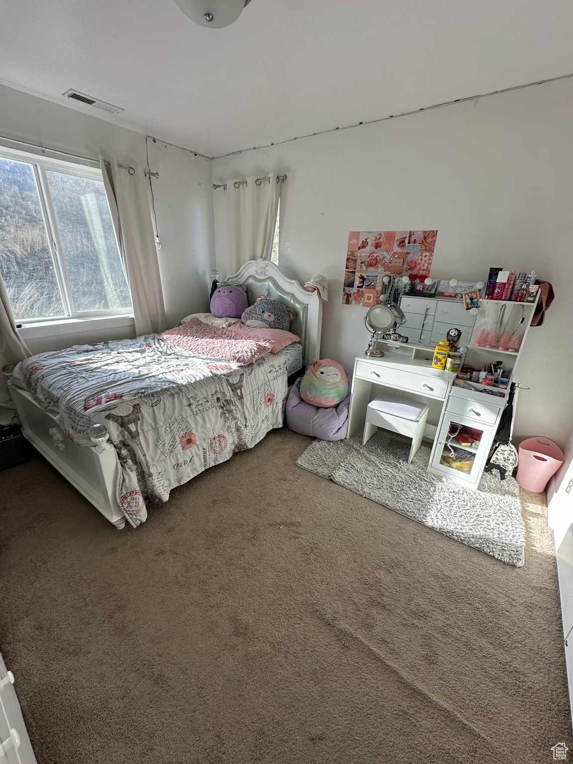 Carpeted bedroom featuring visible vents