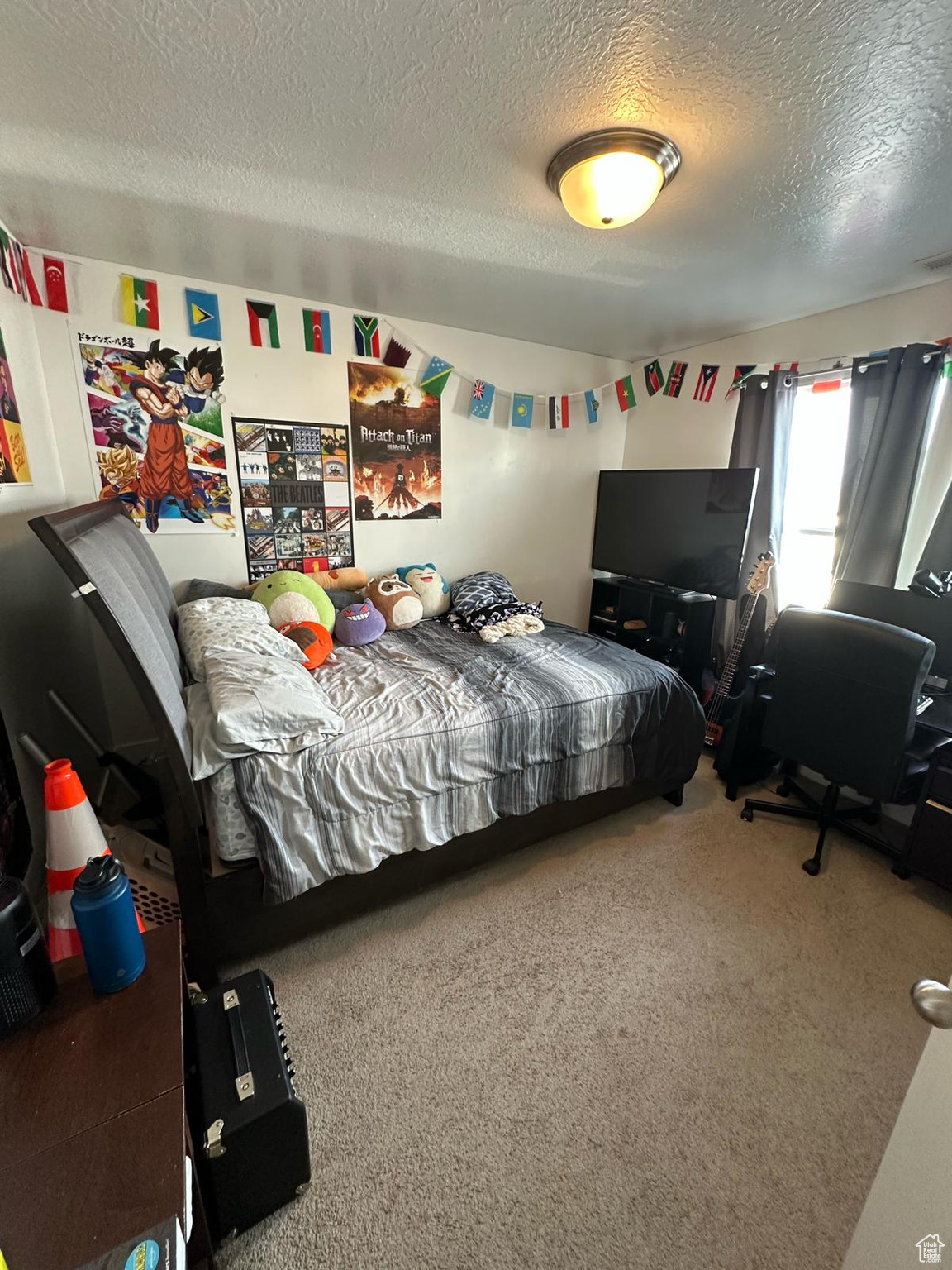 Bedroom featuring carpet and a textured ceiling