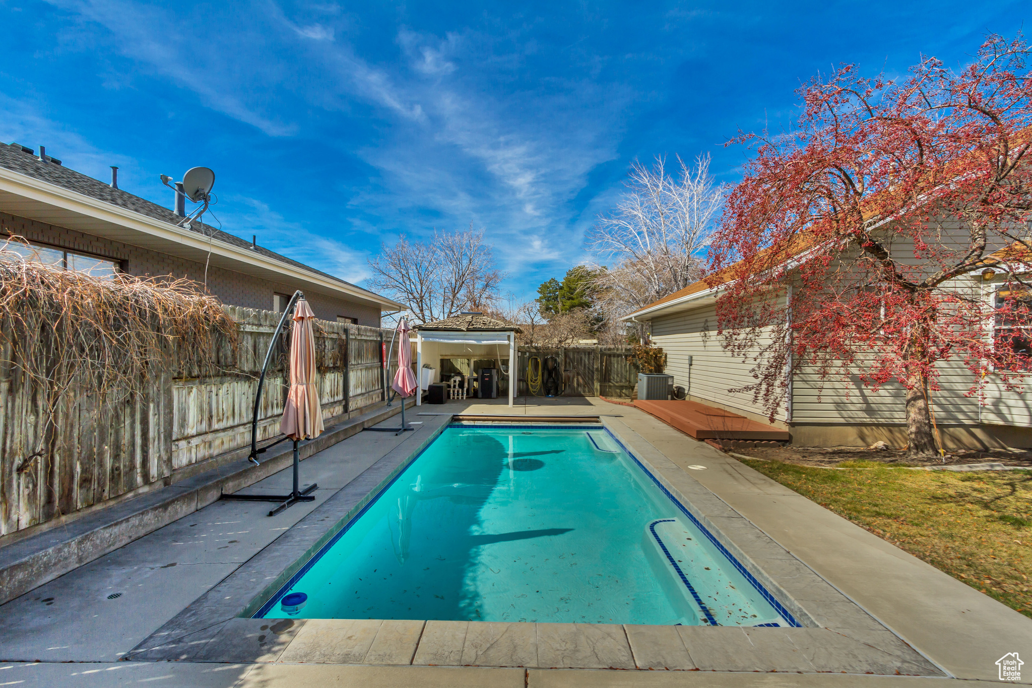 View of pool featuring a gazebo, a fenced in pool, and a fenced backyard