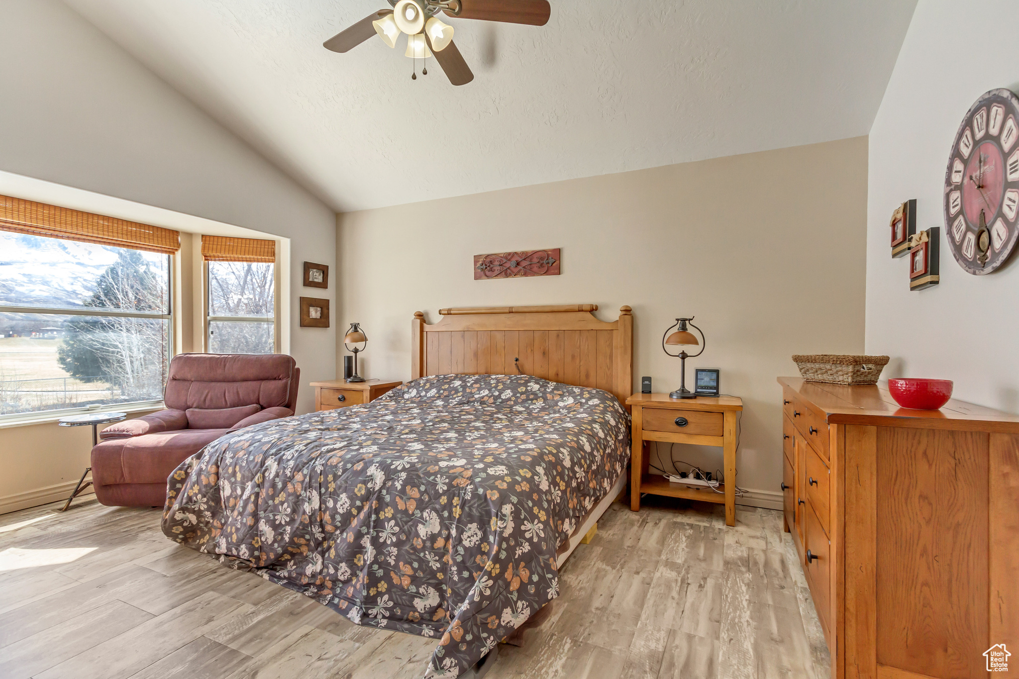 Bedroom with light wood-type flooring, baseboards, ceiling fan, and vaulted ceiling
