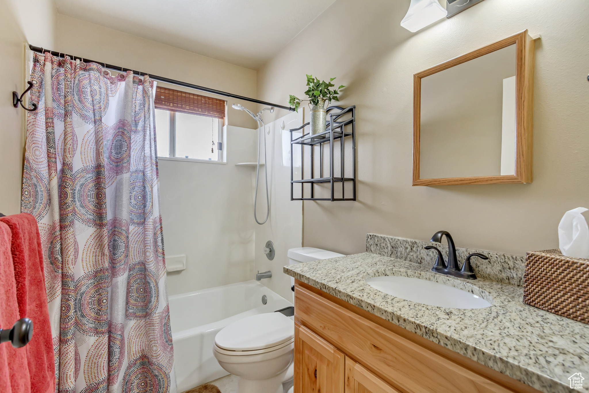 Full bath featuring toilet, shower / bath combo, and vanity