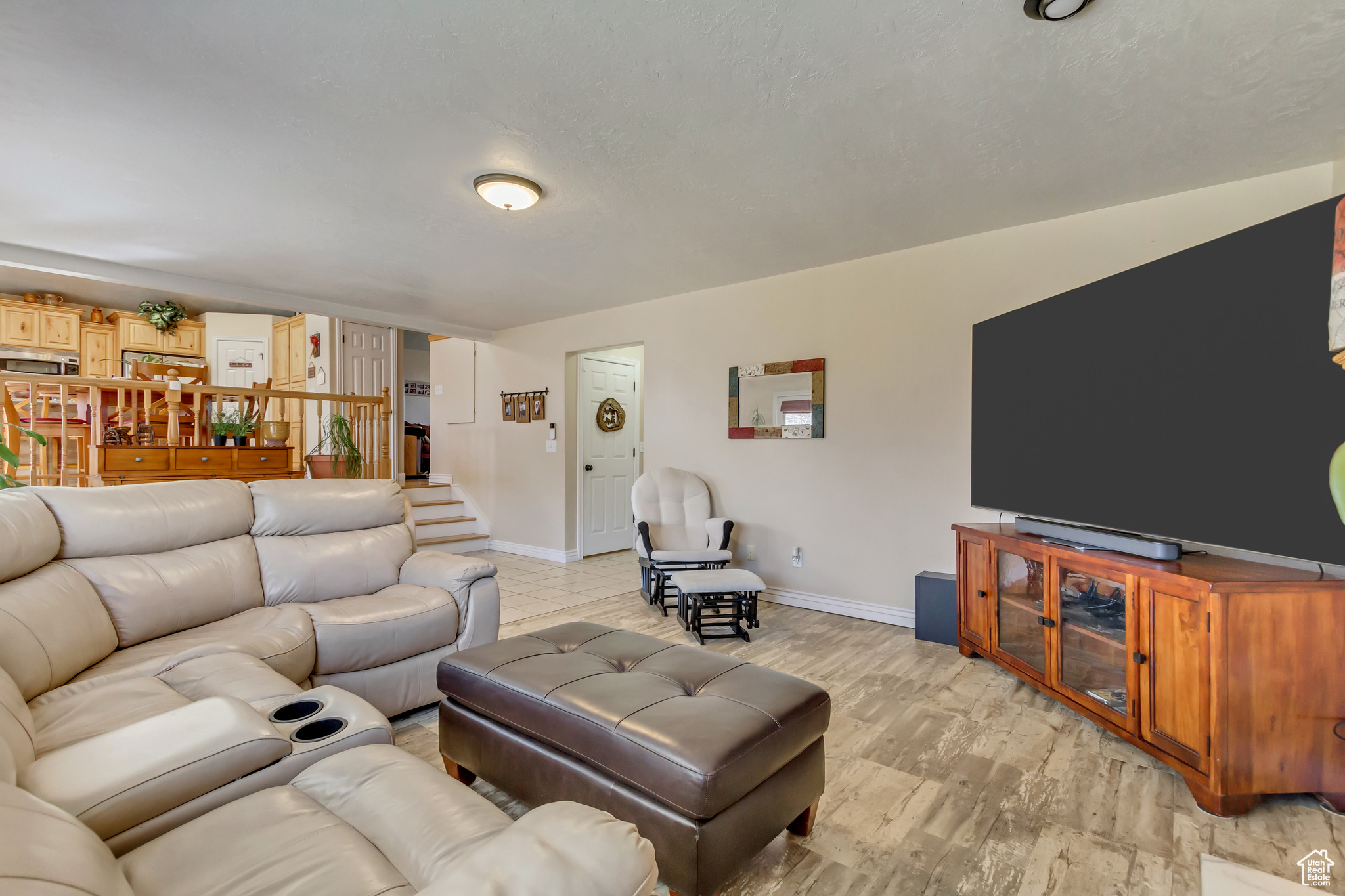Living area with stairs and baseboards