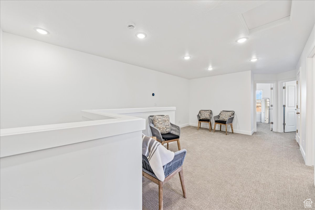 Sitting room featuring recessed lighting, baseboards, and light colored carpet