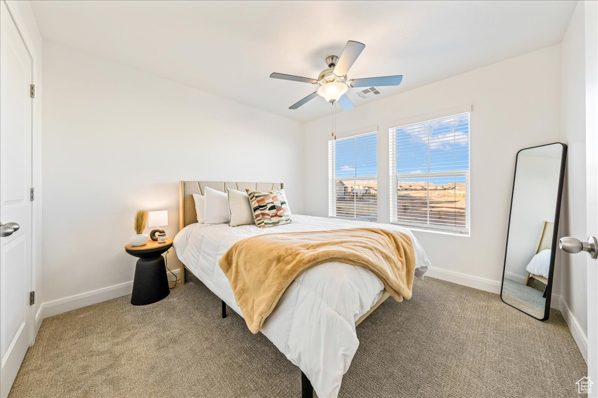 Bedroom featuring visible vents, baseboards, and light colored carpet