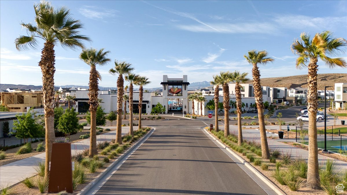 View of road featuring sidewalks, traffic signs, curbs, and a residential view