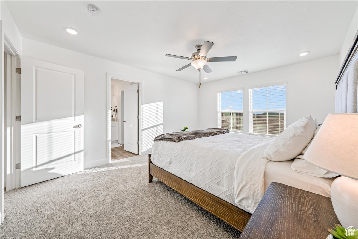 Bedroom featuring recessed lighting, visible vents, light colored carpet, and ceiling fan