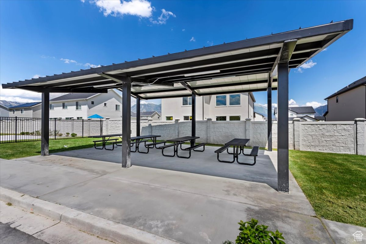 Exterior space featuring a patio area, a yard, and a fenced backyard