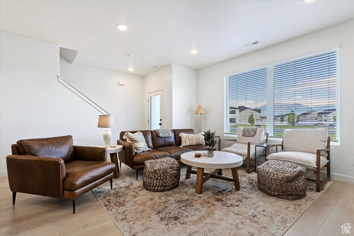 Living room featuring recessed lighting, light wood-type flooring, and baseboards