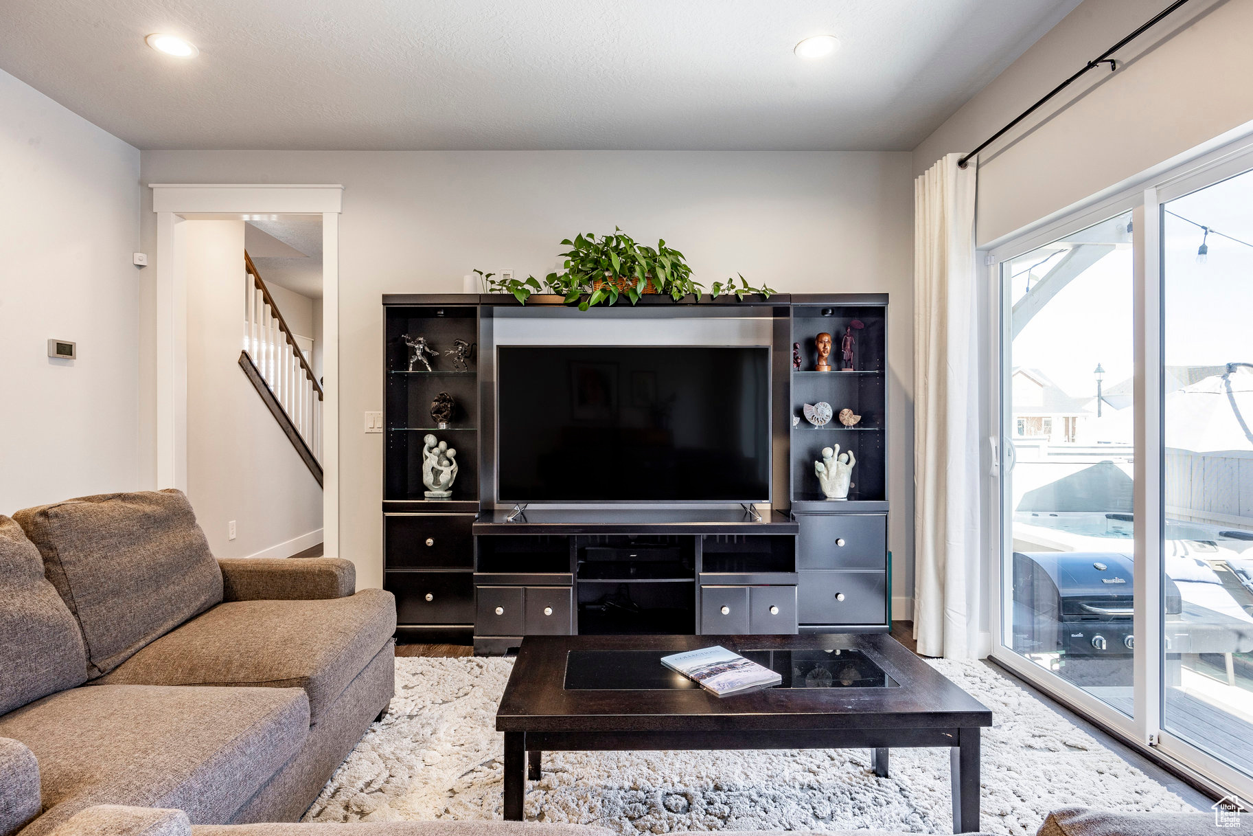 Living room featuring recessed lighting and stairway