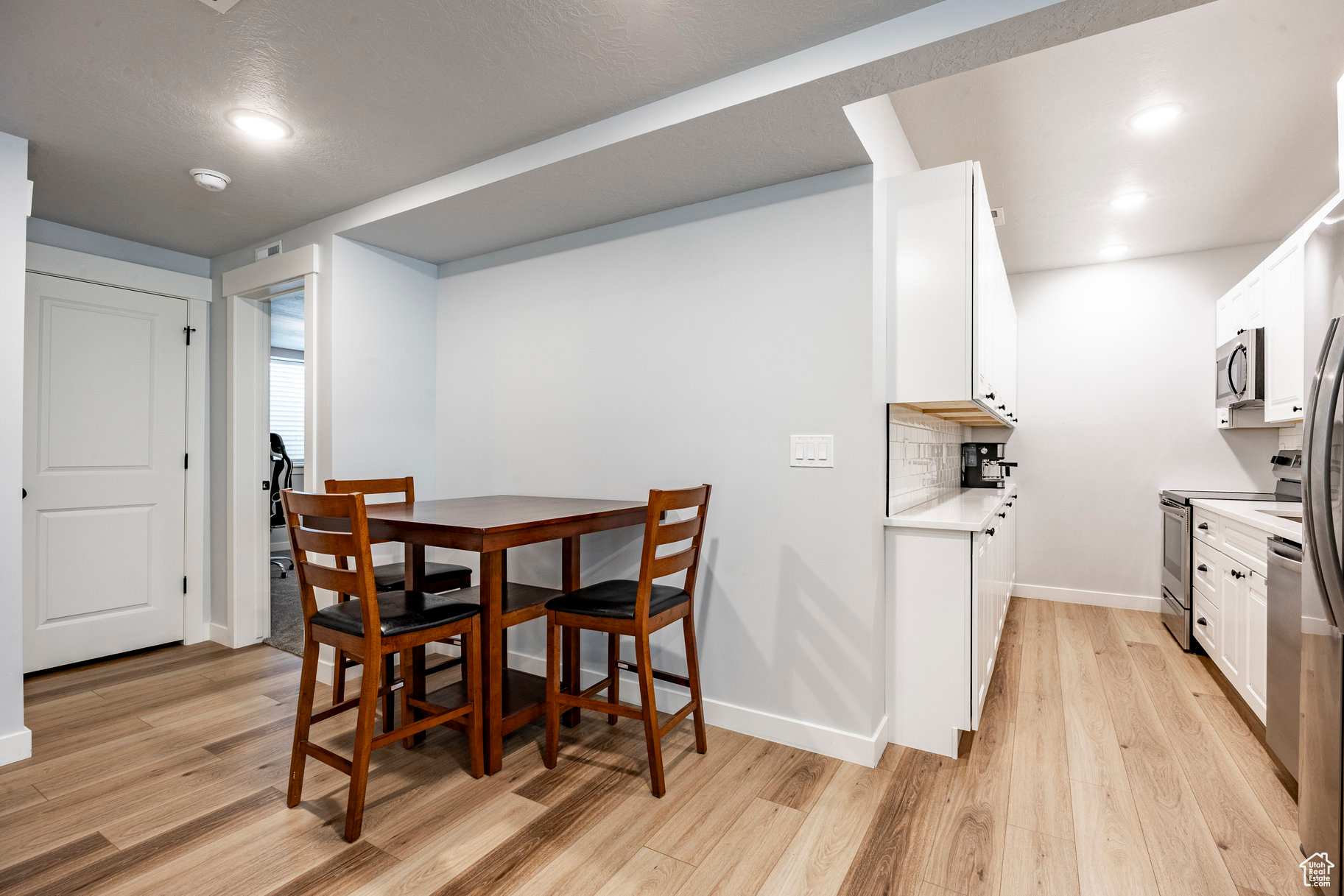 Dining area with recessed lighting, baseboards, and light wood finished floors