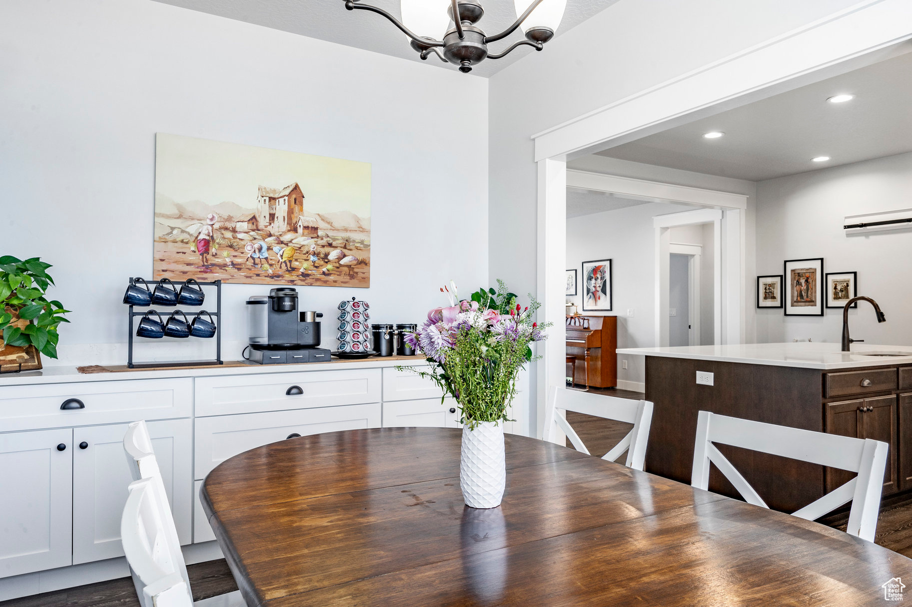 Dining space with recessed lighting and an inviting chandelier