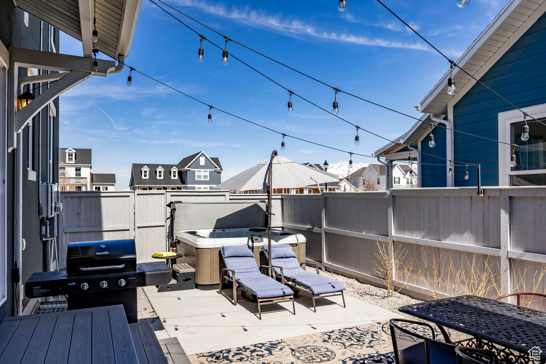 Deck featuring a grill, a fenced backyard, and a hot tub