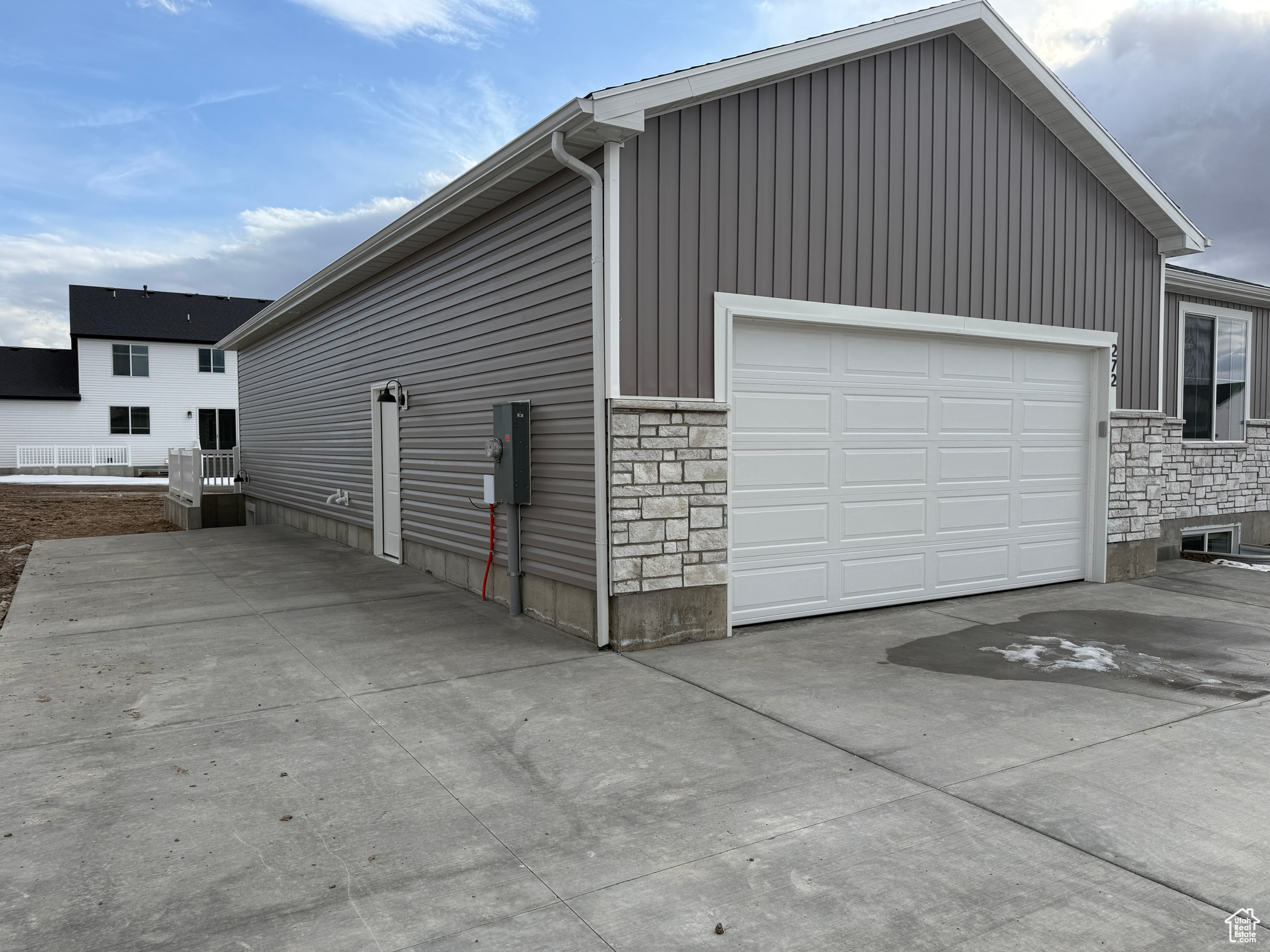 Garage featuring concrete driveway