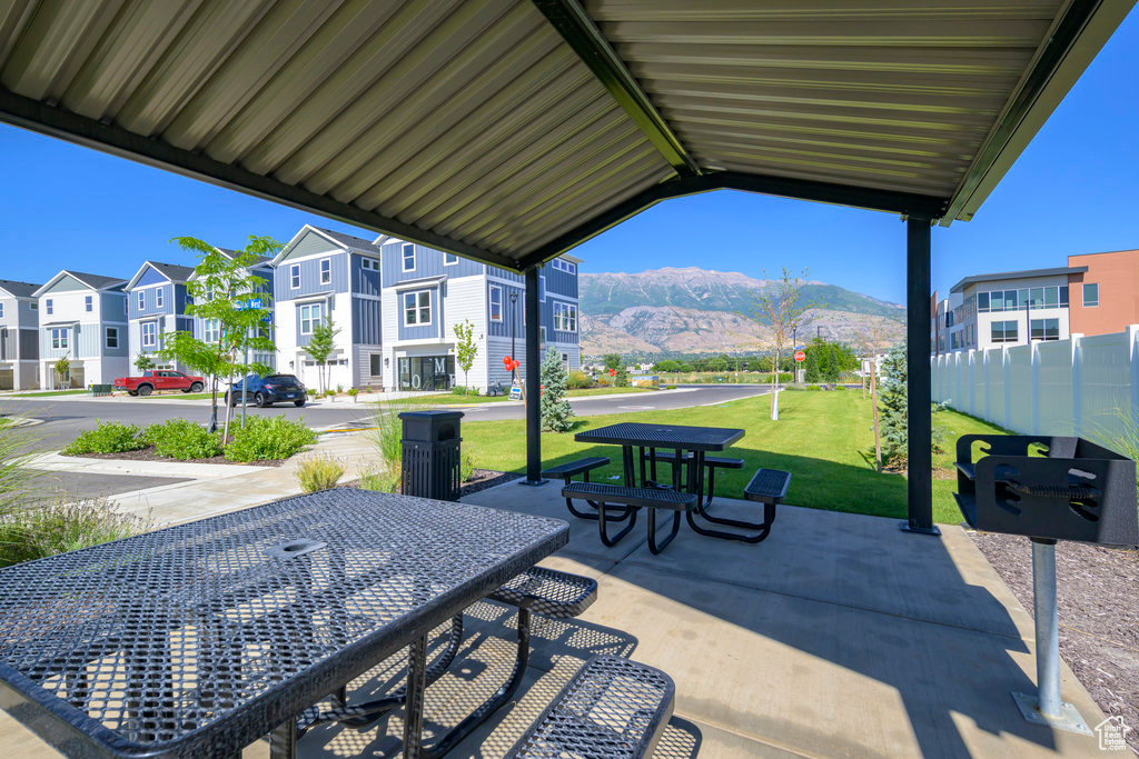 View of patio / terrace featuring a mountain view, a residential view, and outdoor dining space