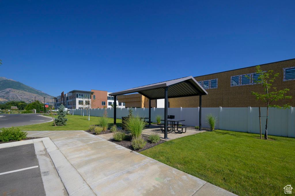View of patio with fence and a mountain view