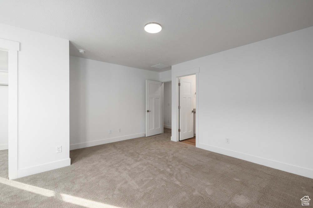 Interior space with baseboards and carpet