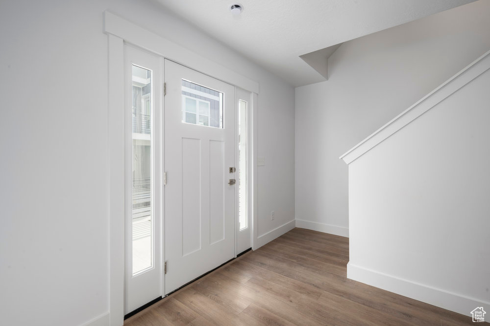 Foyer with wood finished floors and baseboards
