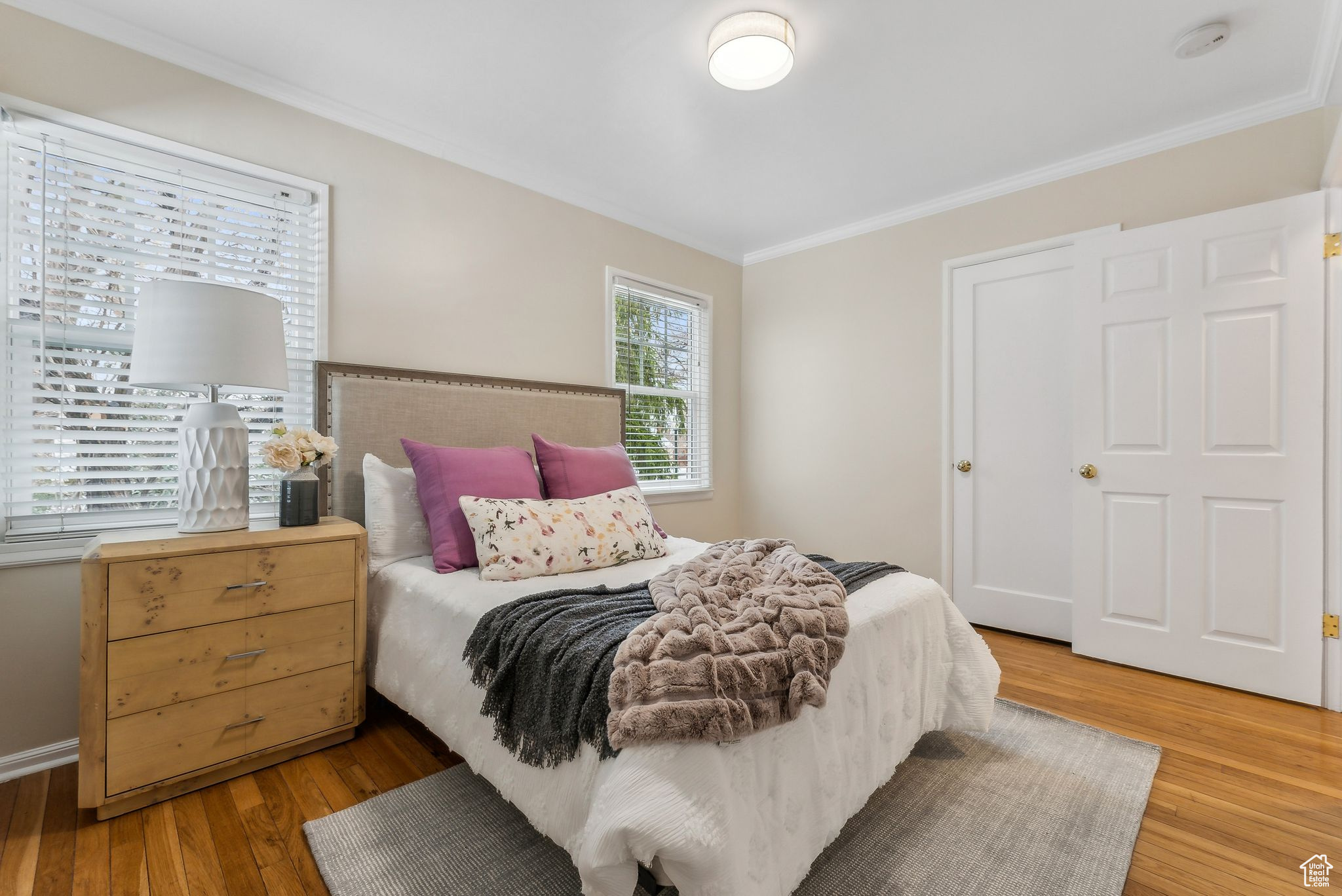 Bedroom featuring light wood-style floors and ornamental molding