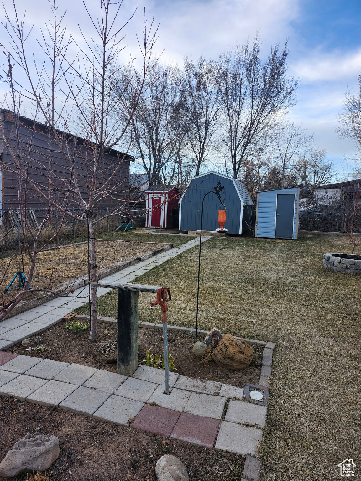 View of yard featuring an outbuilding and a storage shed