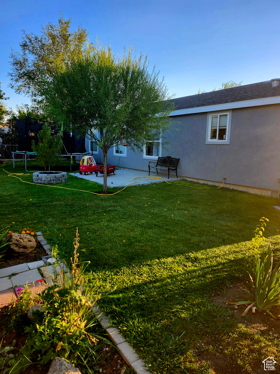 View of yard with a patio and a trampoline