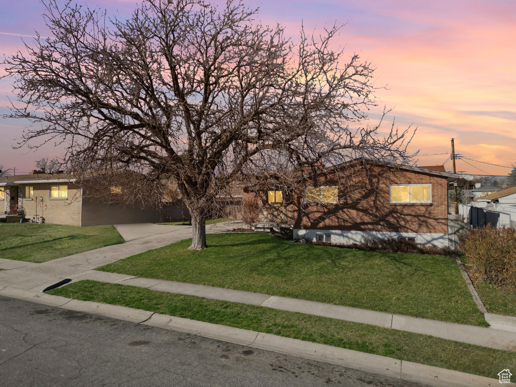 View of front of property with a yard and brick siding