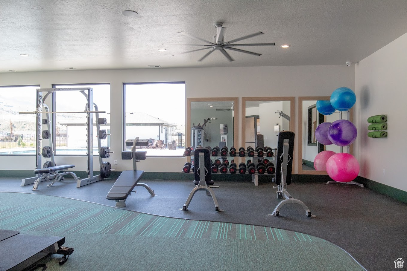 Workout area with recessed lighting, baseboards, and a textured ceiling