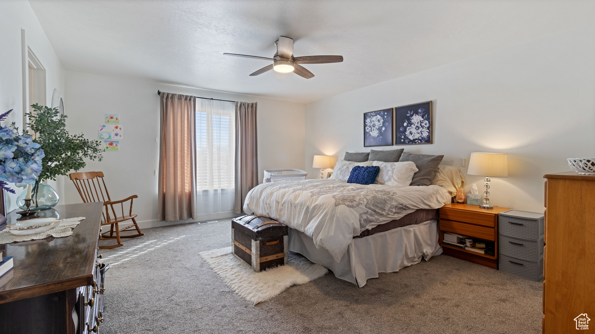 Bedroom featuring baseboards, ceiling fan, and carpet flooring