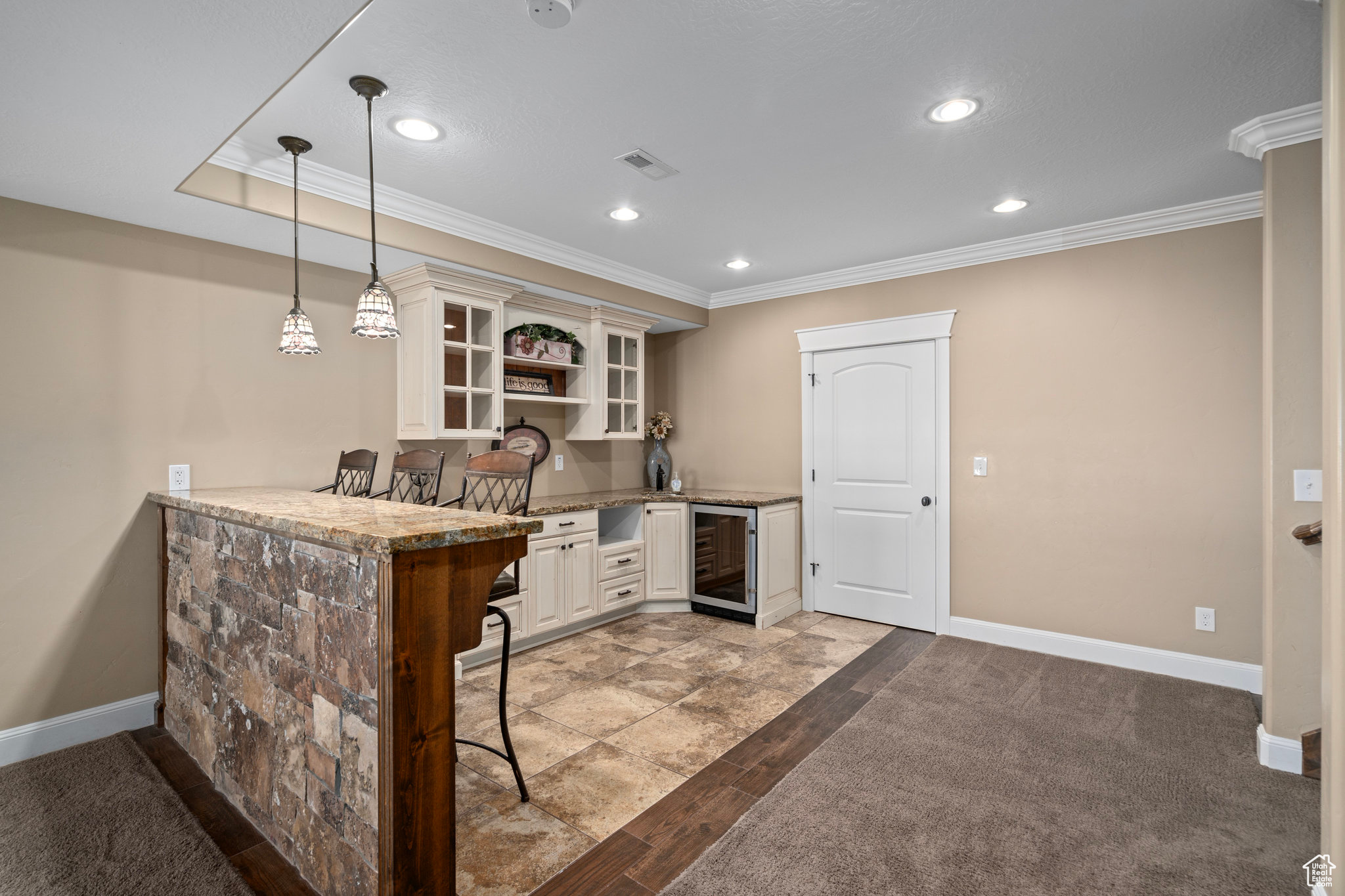 Kitchen featuring baseboards, open shelves, recessed lighting, wine cooler, and crown molding