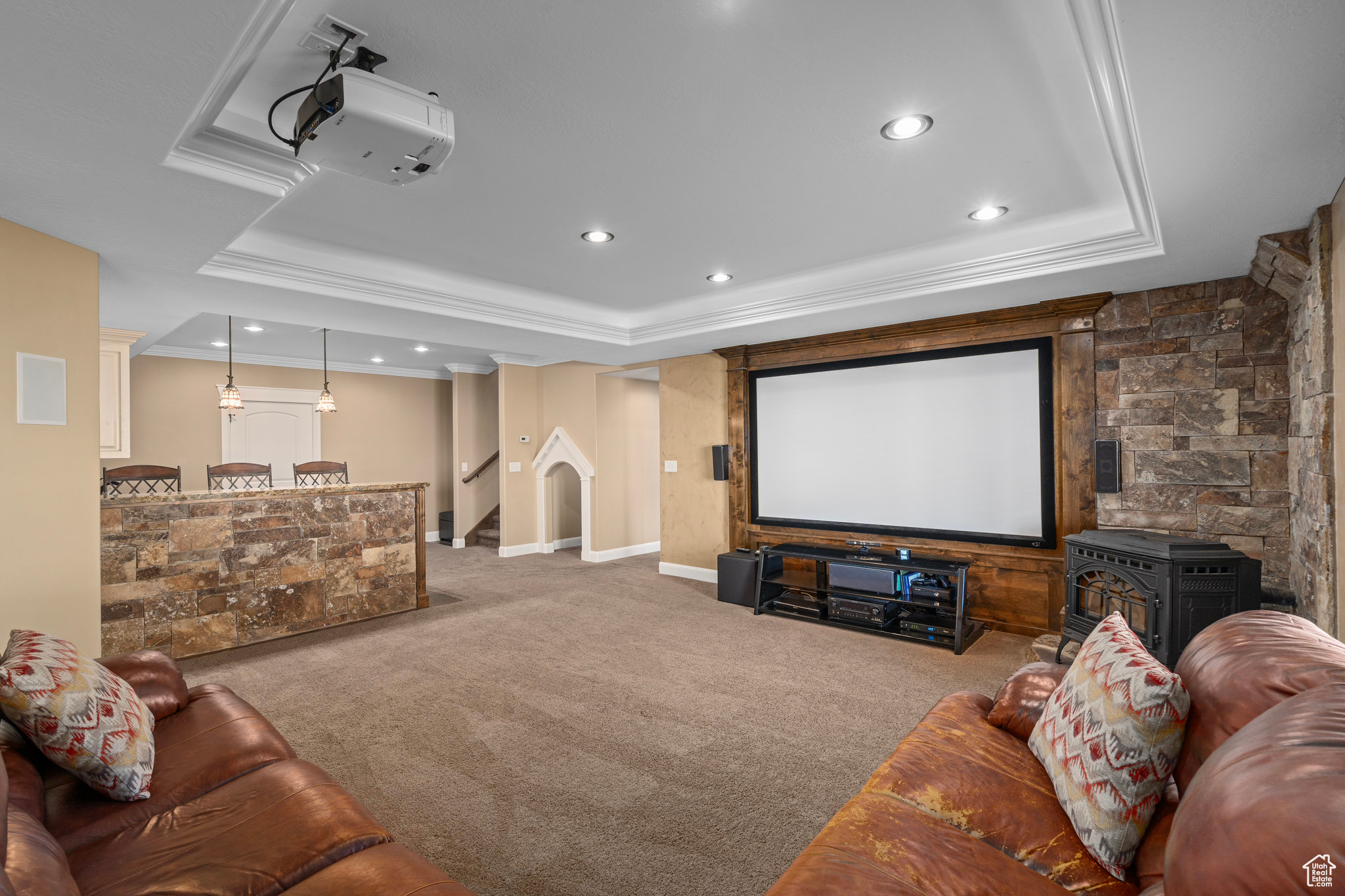 Cinema featuring recessed lighting, crown molding, a raised ceiling, and carpet