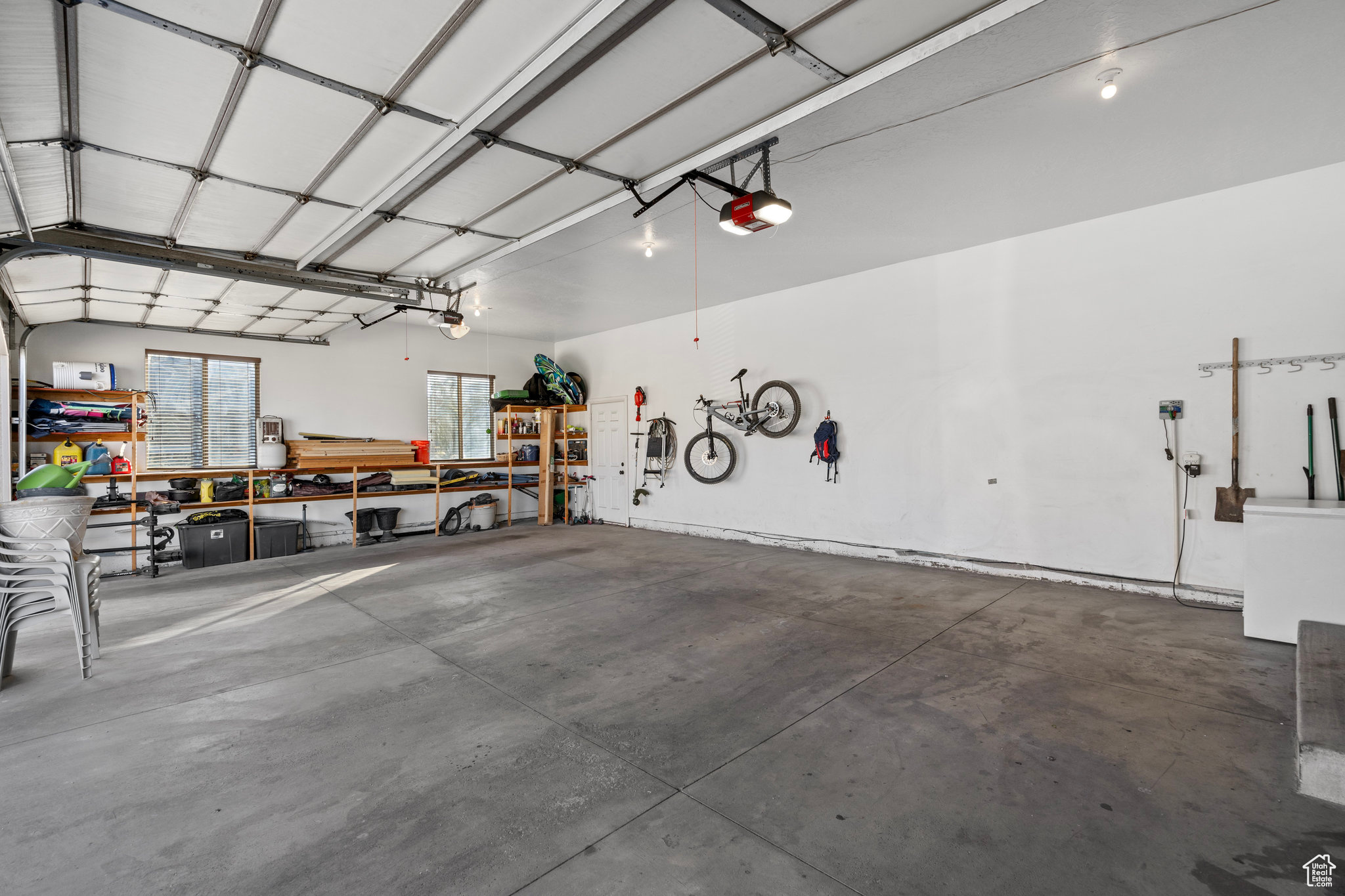 Garage featuring a workshop area and a garage door opener