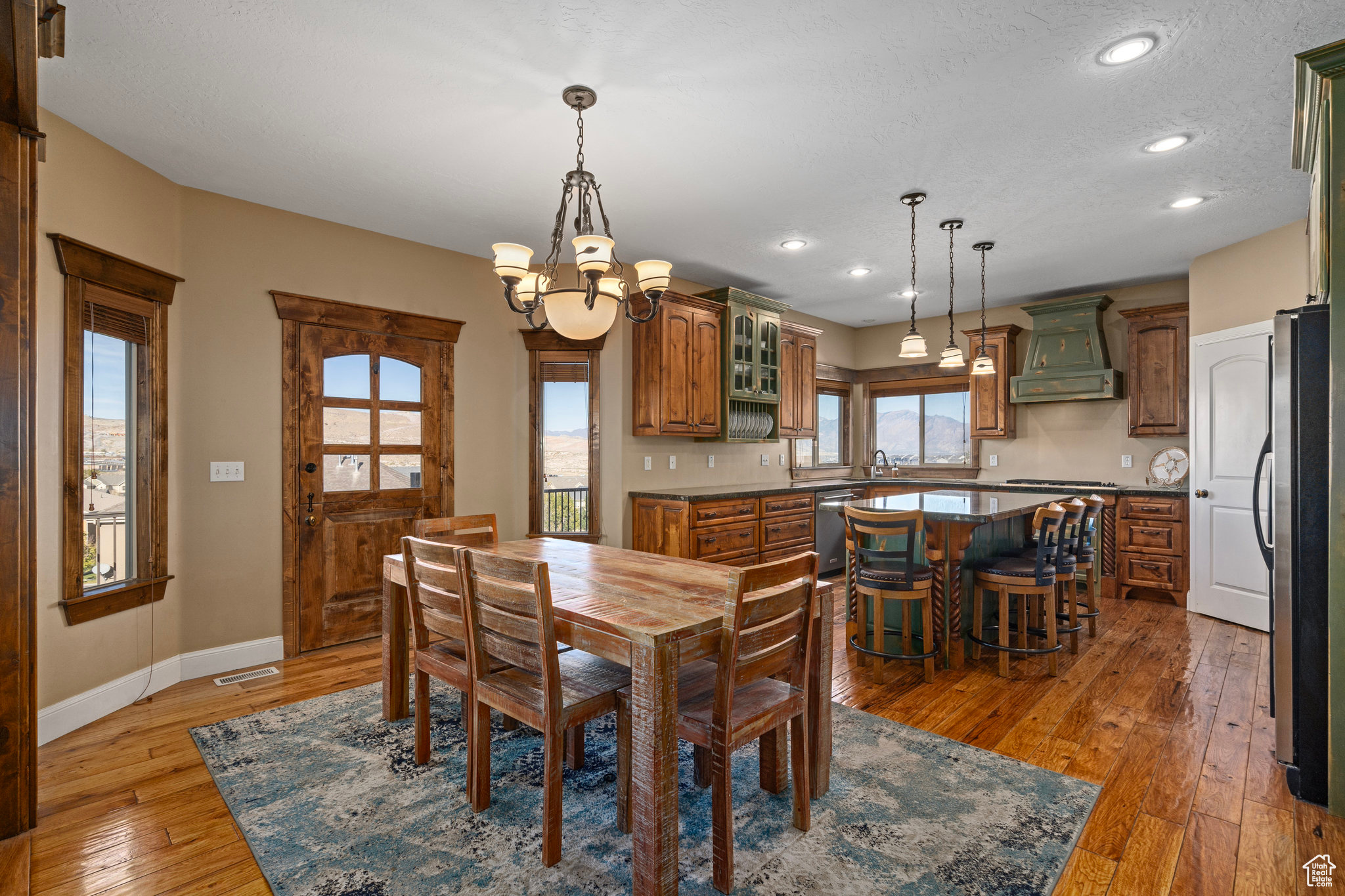 Dining space with visible vents, baseboards, light wood finished floors, recessed lighting, and a chandelier