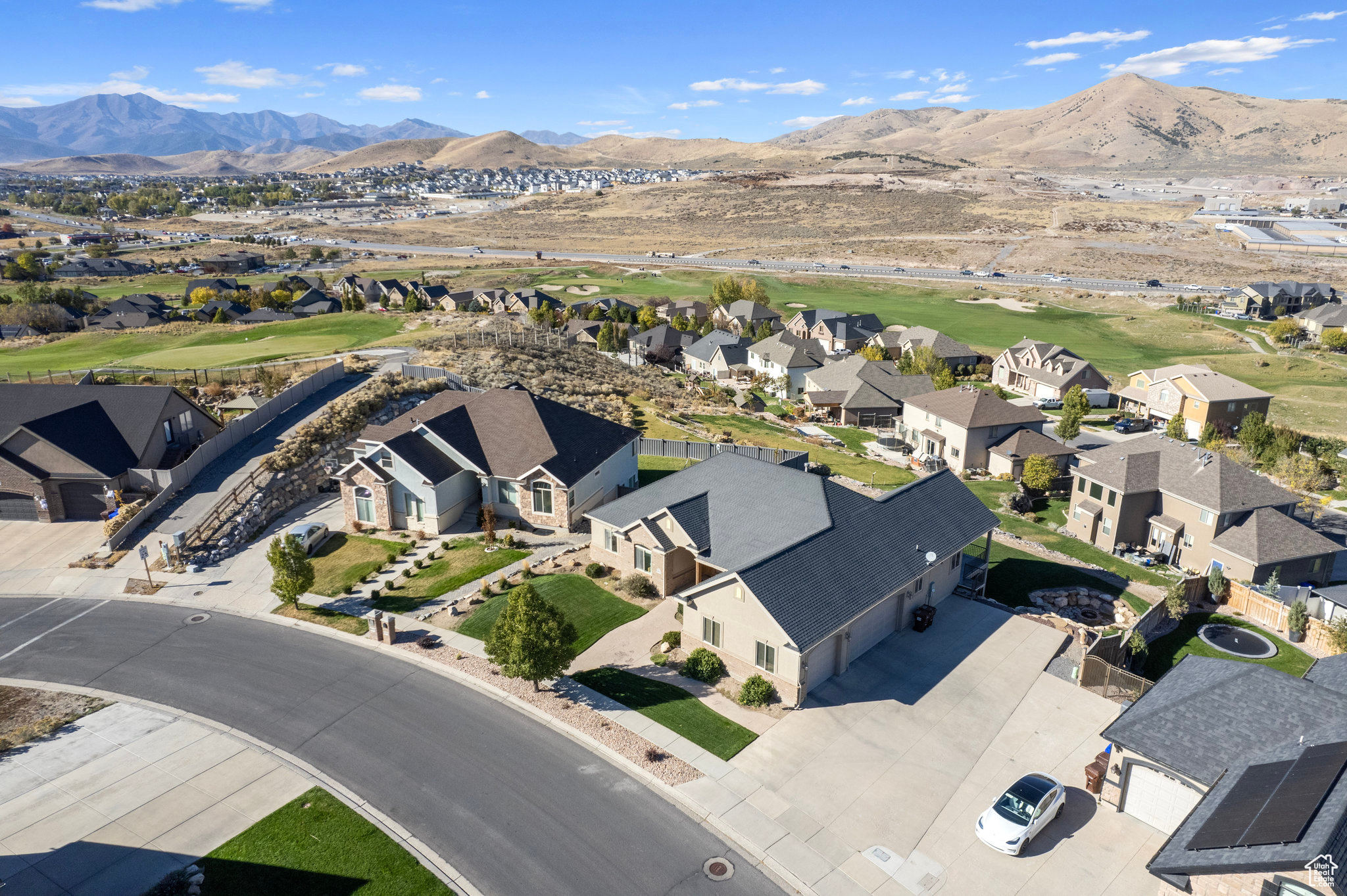 Birds eye view of property with view of golf course, a mountain view, and a residential view