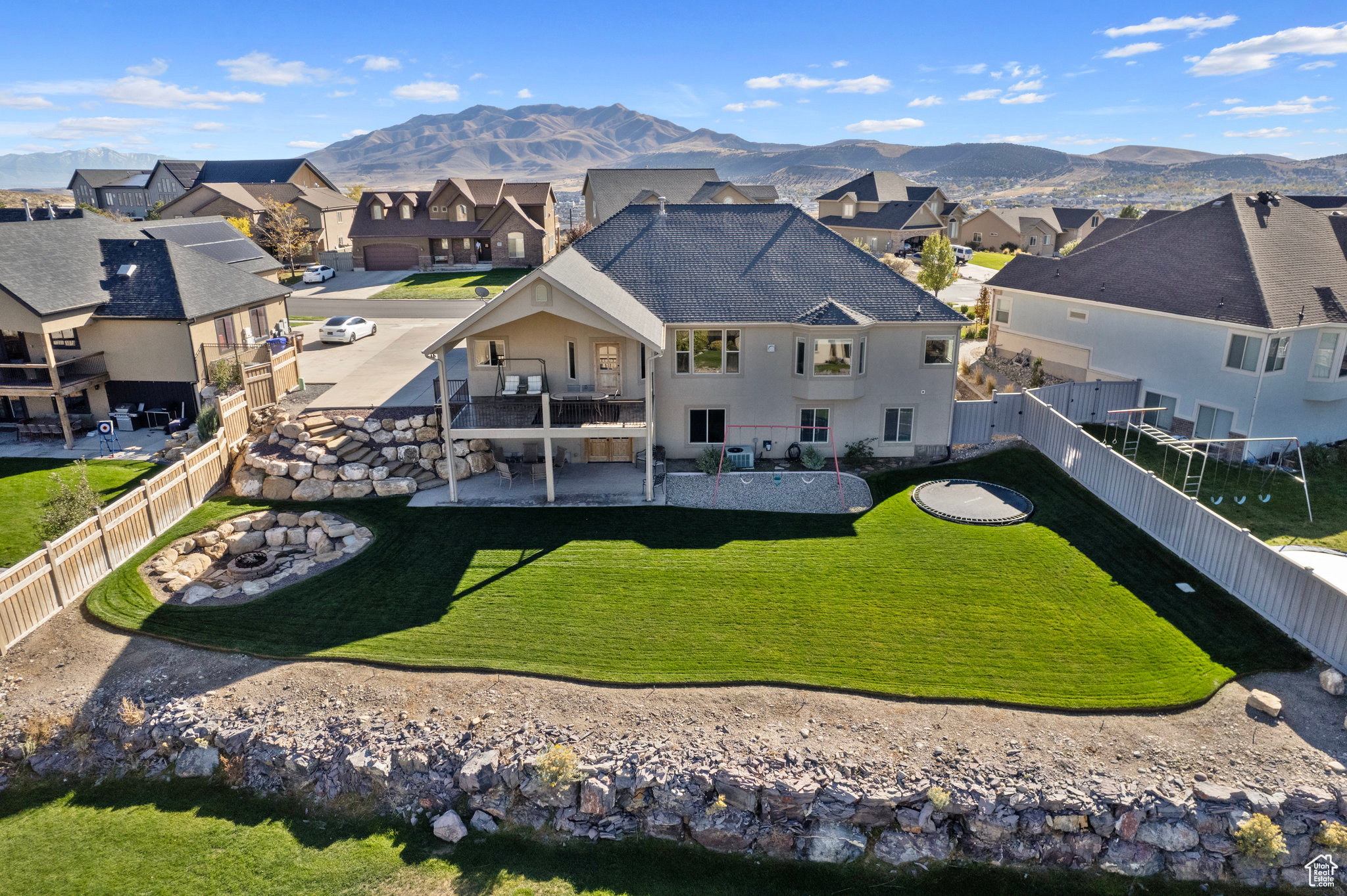 Rear view of property featuring a yard, a residential view, a fenced backyard, and a patio