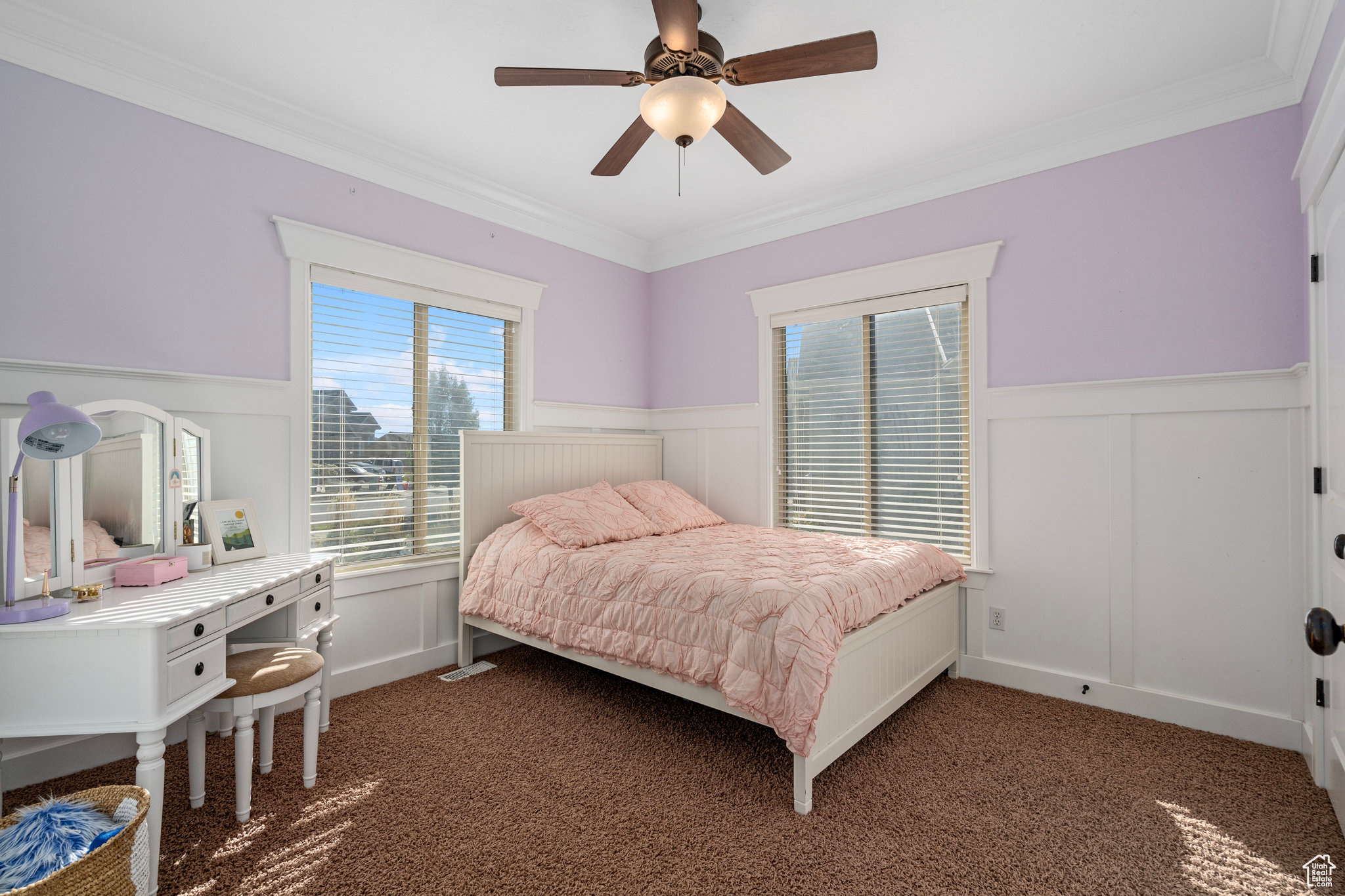 Bedroom featuring carpet flooring, crown molding, ceiling fan, and a wainscoted wall
