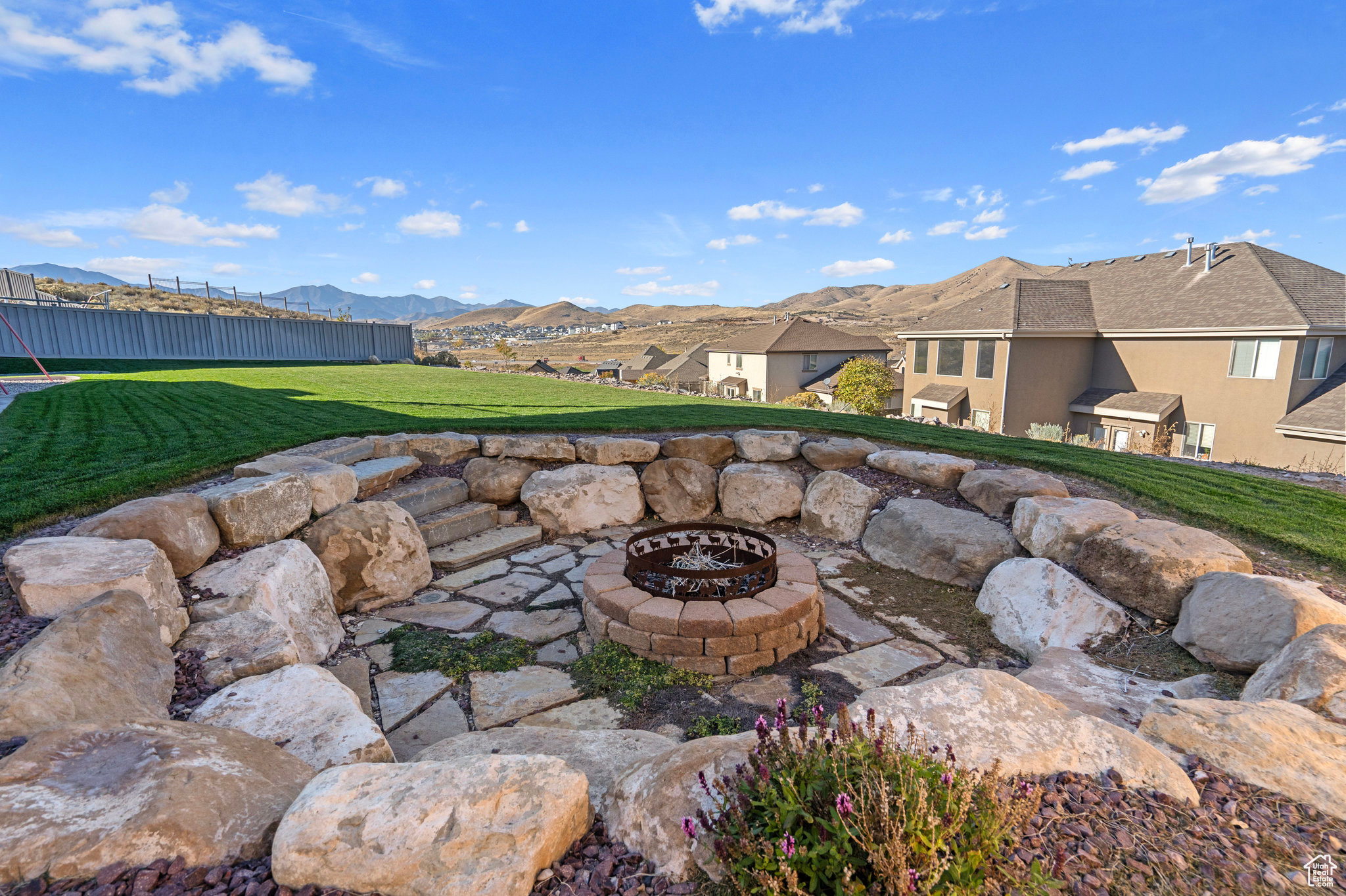 View of patio featuring a mountain view, a fire pit, and fence