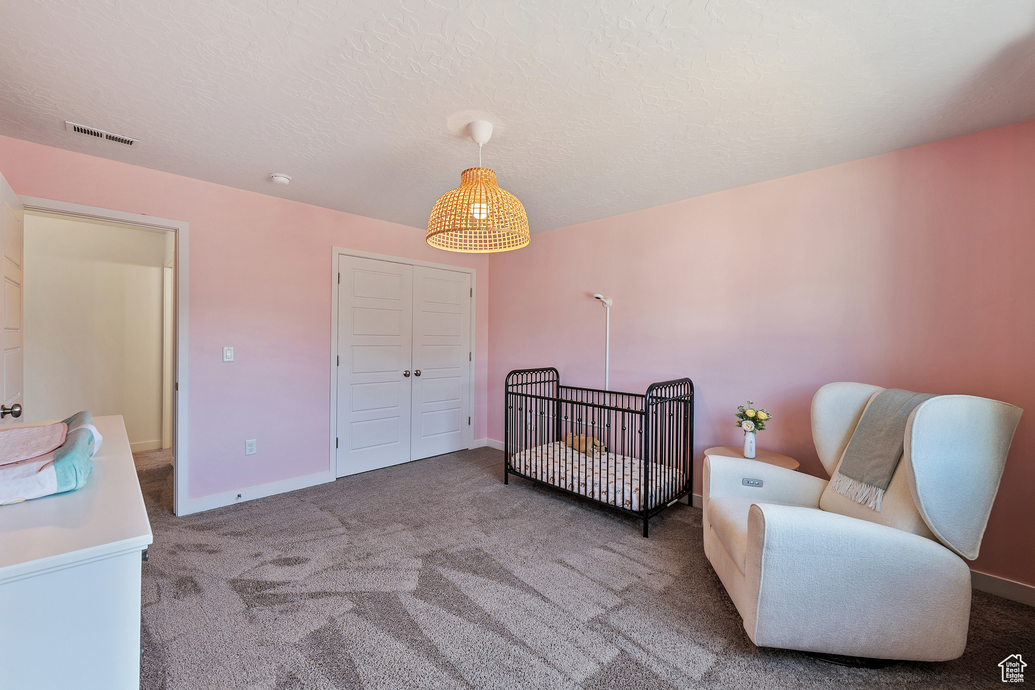 Bedroom featuring carpet, visible vents, baseboards, a closet, and a textured ceiling
