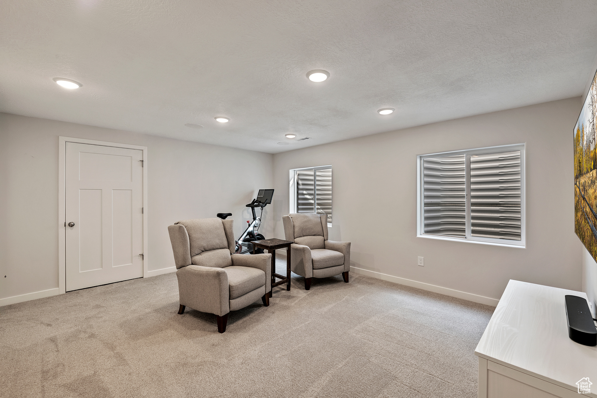 Sitting room with recessed lighting, baseboards, and light carpet
