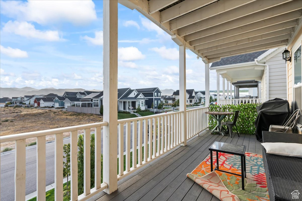 Wooden deck with a residential view and area for grilling