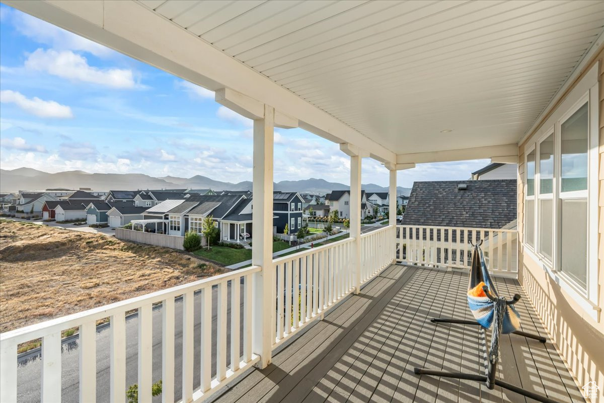 Wooden terrace featuring a residential view and a mountain view