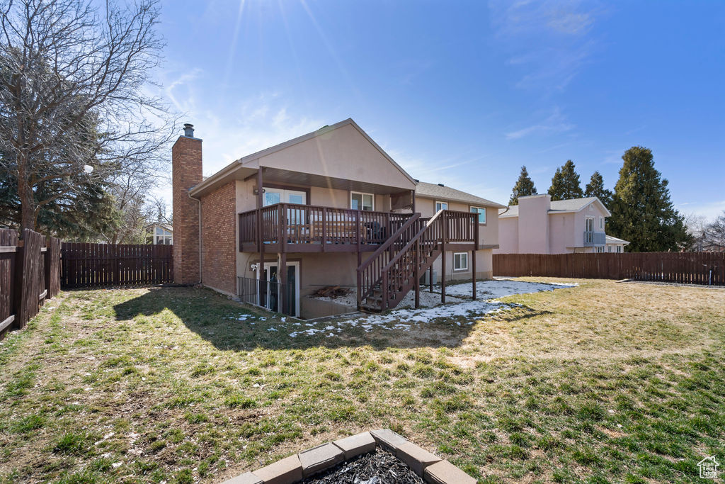 Back of property featuring stairway, a patio, a yard, and a fenced backyard