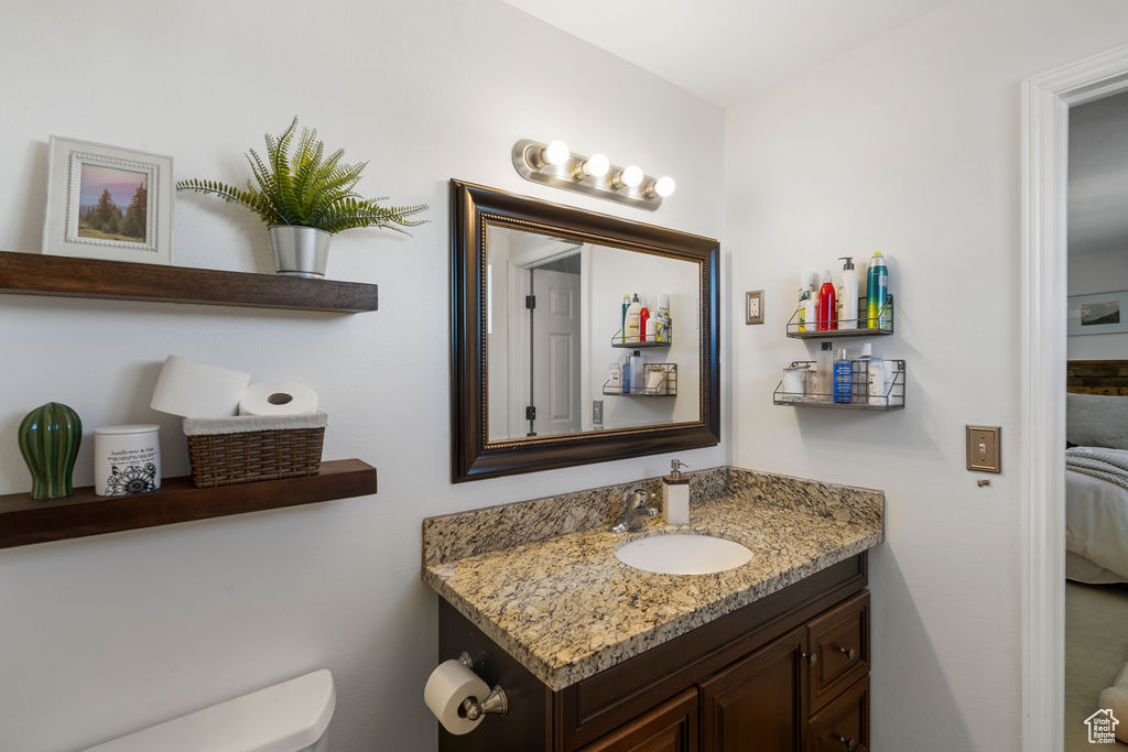 Bathroom with ensuite bath, toilet, and vanity